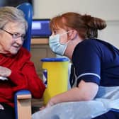 Resident Annie Innes, 90, talks with a healthcare worker at the Abercorn House Care Home in Hamilton.
