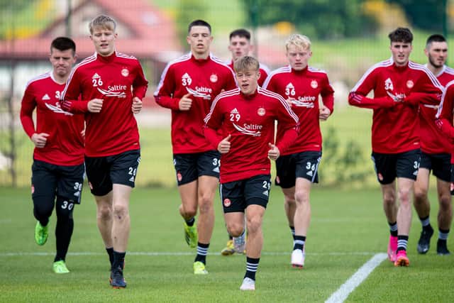 Barron (centre) signed a new contract for Aberdeen earlier this month.