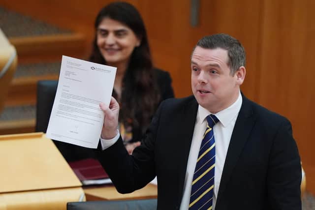 Scottish Conservative leader Douglas Ross holds up a letter written to him by First Minister Humza Yousaf during First Minster's Questions (Photo:Andrew Milligan/PA Wire)