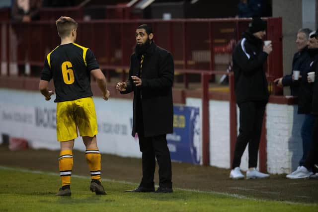 Iftikhar gives instructions to Fort William player Taylor Kelly.