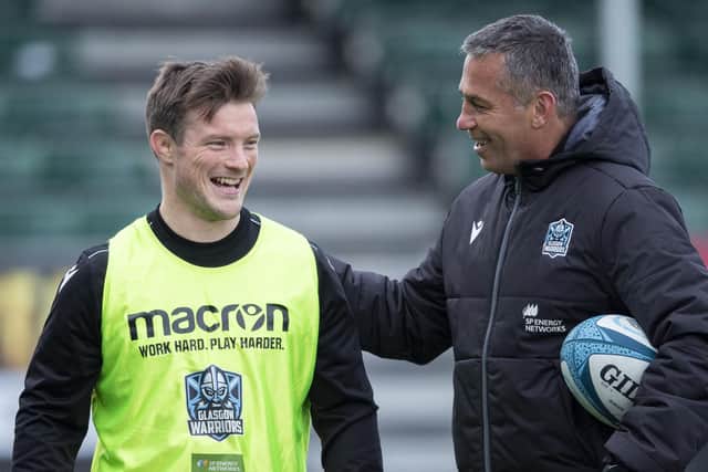 Head coach Franco Smith shares a joke with George Horne ahead of Glasgow Warriors' match against Zebre.