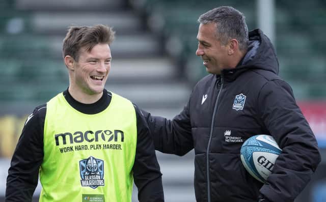 Head coach Franco Smith shares a joke with George Horne ahead of Glasgow Warriors' match against Zebre.
