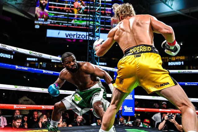 Floyd Mayweather crouches against Logan Paul in their exhibition fight in Miami. Picture: CHANDAN KHANNA/AFP via Getty Images