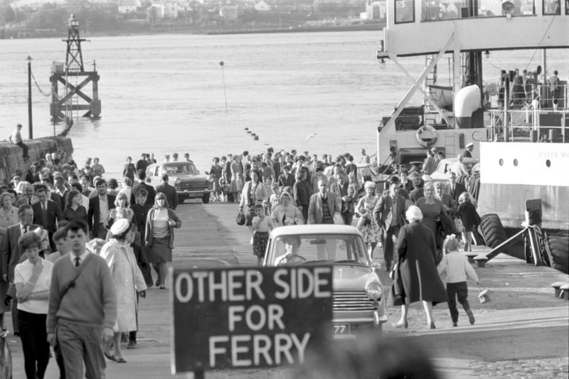 People and cars turned out en masse to see the opening of the Forth Road Bridge in September 1964 - cars and crowds coming off the ferry at South Queensferry.