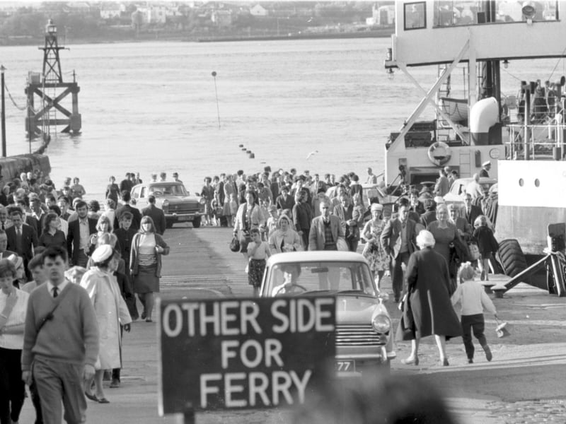 People and cars turned out en masse to see the opening of the Forth Road Bridge in September 1964 - cars and crowds coming off the ferry at South Queensferry.