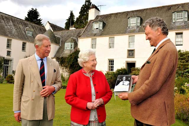 Queen Elizabeth II with Prince Charles, Prince of Wales, in 2009 as they are presented with one of the first copies of 'Queen Elizabeth the Queen Mother, The Official Biography' by author William Shawcross in the garden at Birkhall, Scotland. Image: Getty