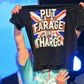 Reform UK leader Nigel Farage was joined on stage by a supporter at a Reform UK Scotland press conference in Bishopton, Glasgow, in March (Picture: Andy Buchanan/AFP via Getty Images)