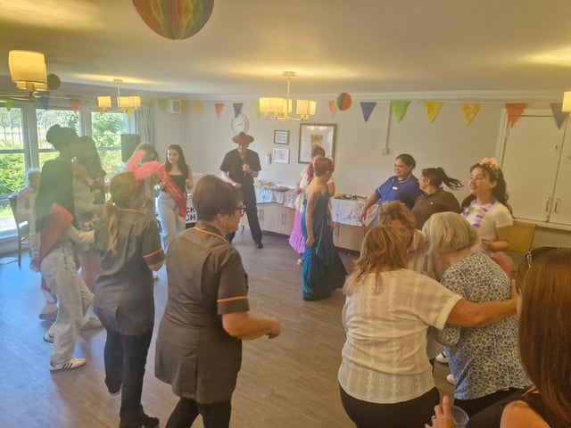Group dance with queen at HC-One Scotland’s Fullarton Care Home celebrating Marymass festival