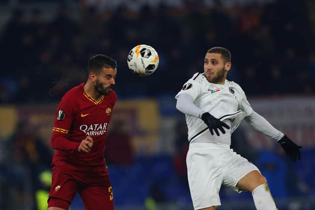 Shon Weissman of Wolfsberger AC in action with Leonardo Spinazzola of AS Roma during a Europa League match in December 2019