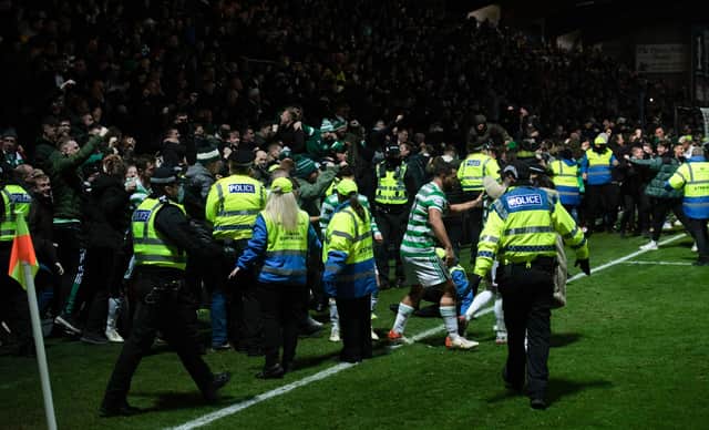 Celtic fans spill on to the pitch after Anthony Ralston's goal makes it 2-1 in dramatic circumstances at Dingwall. (Photo by Craig Foy / SNS Group)