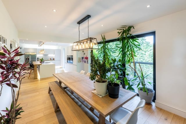 Interior: An entrance vestibule with roof cupola leads to an open-plan kitchen, dining and living space, featuring bi-folding doors. There is a gym and playroom, while its four bedrooms are on the first level.