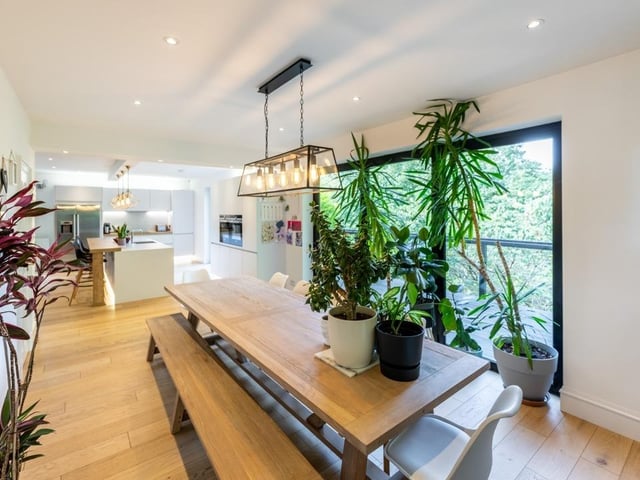 Interior: An entrance vestibule with roof cupola leads to an open-plan kitchen, dining and living space, featuring bi-folding doors. There is a gym and playroom, while its four bedrooms are on the first level.