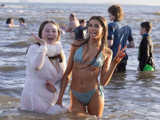 Over one hundred people take part in the Kinghorn Loony Dook New Years Day swim on the Fife coast of the Firth of Forth