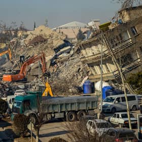 Bulldozers work among the rubble of collapsed buildings in Adiyaman, Turkey three days after a 7,8-magnitude earthquake struck southeast Turkey (Photo by ILYAS AKENGIN/AFP via Getty Images)