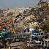 Bulldozers work among the rubble of collapsed buildings in Adiyaman, Turkey three days after a 7,8-magnitude earthquake struck southeast Turkey (Photo by ILYAS AKENGIN/AFP via Getty Images)