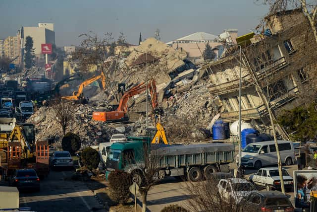 Bulldozers work among the rubble of collapsed buildings in Adiyaman, Turkey three days after a 7,8-magnitude earthquake struck southeast Turkey (Photo by ILYAS AKENGIN/AFP via Getty Images)