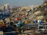 Bulldozers work among the rubble of collapsed buildings in Adiyaman, Turkey three days after a 7,8-magnitude earthquake struck southeast Turkey (Photo by ILYAS AKENGIN/AFP via Getty Images)