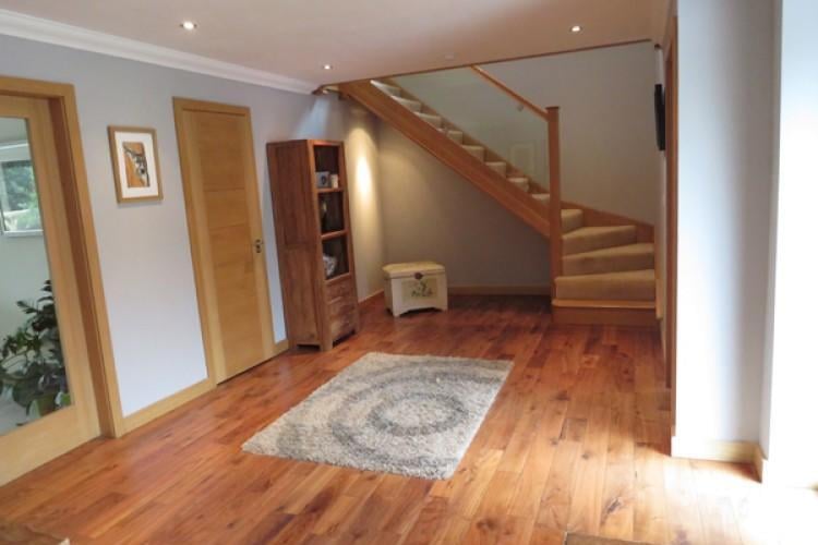 The entrance hall has solid oak staircase and ceiling fitted spot lighting.