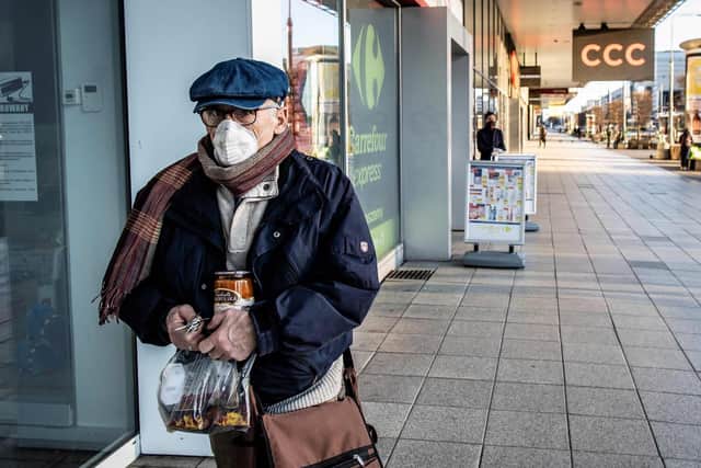 An elderly man with a face mask walks in Poland. (Getty Images)