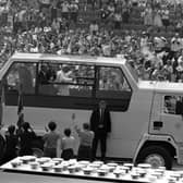 Pope John Paul II waves from the Popemobile as he makes his way through a welcoming crowd at Bellahouston Park.