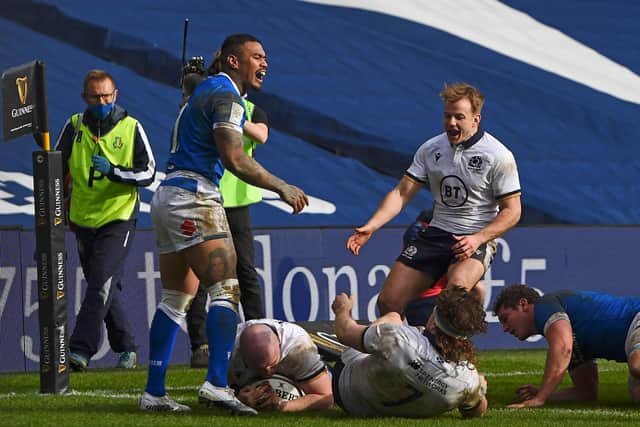 Scotland hooker David Cherry forces his way over against Italy.