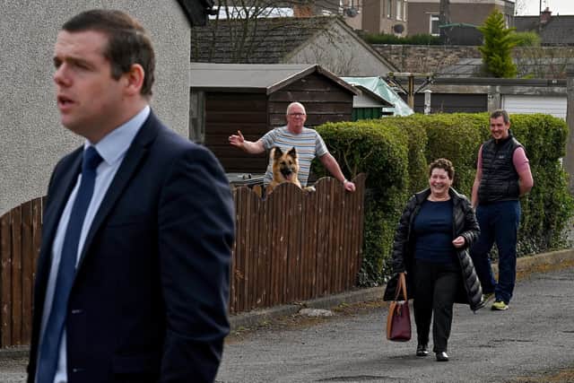 Members of the public watch the Scottish Conservative leader Douglas Ross as he pays a visit to the former Loanhead police station. (Photo by Jeff J Mitchell/Getty Images)