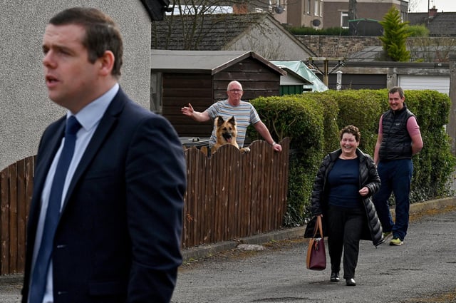 Members of the public watch the Scottish Conservative leader Douglas Ross as he pays a visit to the former Loanhead police station. (Photo by Jeff J Mitchell/Getty Images)