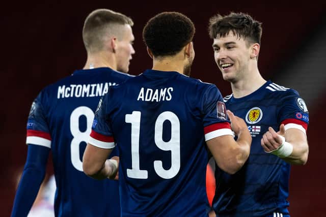 Che Adams, centre, scored his first goal for Scotland while Kieran Tierney, right, put in an excellent performance.