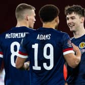 Che Adams, centre, scored his first goal for Scotland while Kieran Tierney, right, put in an excellent performance.