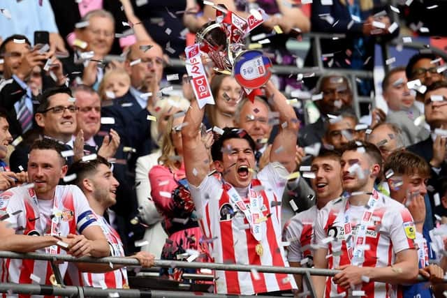 Luke O'Nien of Sunderland celebrates with the Sky Bet League One Play-Off trophy. (Photo by Justin Setterfield/Getty Images)