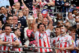 Luke O'Nien of Sunderland celebrates with the Sky Bet League One Play-Off trophy. (Photo by Justin Setterfield/Getty Images)