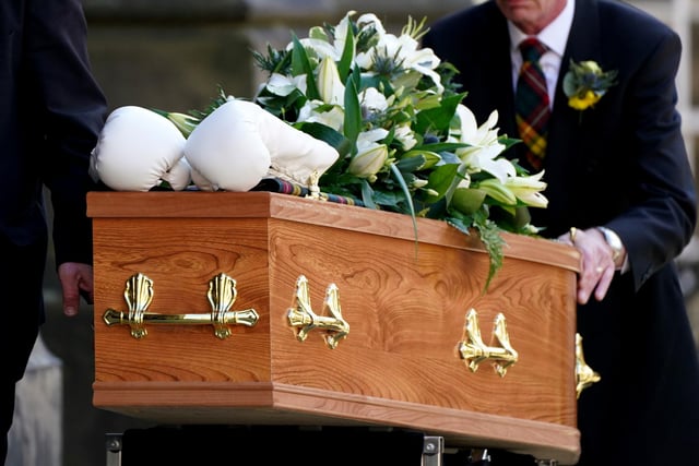 A pair of white boxing gloves rest on the coffin of former boxer Ken Buchanan at St Giles' Cathedral, Edinburgh, ahead of a memorial service. The Scottish boxing great, who became the undisputed world lightweight champion in 1971, died at the beginning of the month, aged 77.