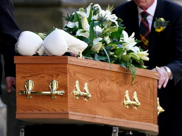 A pair of white boxing gloves rest on the coffin of former boxer Ken Buchanan at St Giles' Cathedral, Edinburgh, ahead of a memorial service. The Scottish boxing great, who became the undisputed world lightweight champion in 1971, died at the beginning of the month, aged 77.