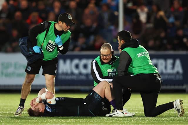 Team doctor John Hanson and physios Michael Clark and Andrew Boag treat Glasgow Warriors hooker Johnny Matthews.
