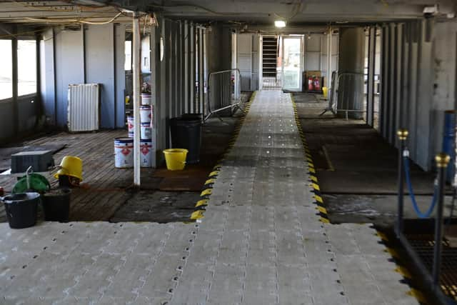 Restoration work on Queen Mary's promenade deck this week. Picture: John Devlin