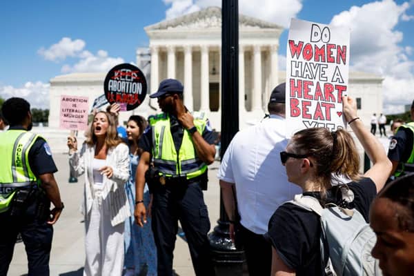 Anti-abortion activists protest near a Women's March rally in front of the US Supreme Court Building in June to mark the one year anniversary of the US Supreme Court’s decision which overturned Roe v Wade and erased federal protections for abortions.