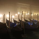 Gondolas lie moored in fog on the Grand Canal, Venice PIC: Sean Gallup/Getty Images