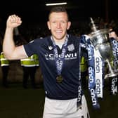 Dundee's Lee Ashcroft with the Championship trophy after the 5-3 win over Queen's Park at Ochilview. (Photo by Alan Harvey / SNS Group)