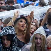 Patrons try to shield from the rain at TRNSMT at Glasgow Green over the weekend. More rain is forecast, with a yellow weather warning issued that covers Glasgow. Picture: Lisa Ferguson
