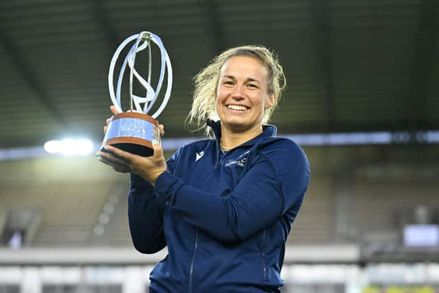 Scotland captain Rachel Malcolm with the WXV 2 trophy.