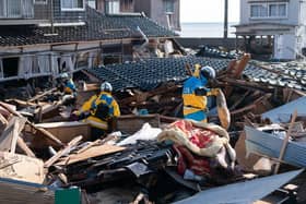 Police officers search for missing persons in the aftermath of an earthquake on New Year's Day in Suzu, Japan. A series of major earthquakes have reportedly killed at least 78 people, injured dozens more and destroyed a large amount of homes.