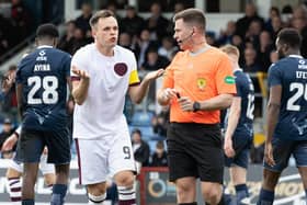 Hearts' Lawrence Shankland protests his innocence after being booked by referee Grant Irvine for a dive in the box during the defeat to Ross County. (Photo by Ross Parker / SNS Group)