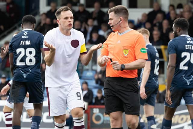 Hearts' Lawrence Shankland protests his innocence after being booked by referee Grant Irvine for a dive in the box during the defeat to Ross County. (Photo by Ross Parker / SNS Group)