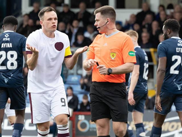Hearts' Lawrence Shankland protests his innocence after being booked by referee Grant Irvine for a dive in the box during the defeat to Ross County. (Photo by Ross Parker / SNS Group)