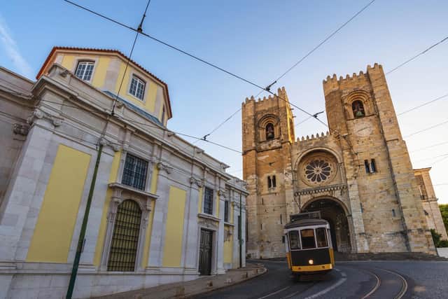 Lisbon Cathedral and one of its much-loved yellow trams.