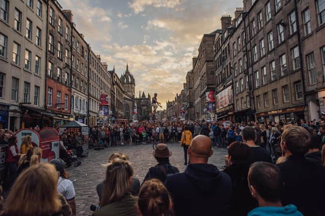 The Royal Mile thronged with visitors watching street theatre during the Edinburgh Festival Fringe. Picture: David Monteith-Hodge