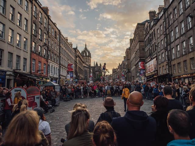 The Royal Mile thronged with visitors watching street theatre during the Edinburgh Festival Fringe. Picture: David Monteith-Hodge