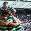 Celtic's Alistair Johnston jumps on top of his team-mates following Cameron Carter-Vickers' goal in the 3-0 win over Hearts.