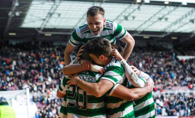 Celtic's Alistair Johnston jumps on top of his team-mates following Cameron Carter-Vickers' goal in the 3-0 win over Hearts.