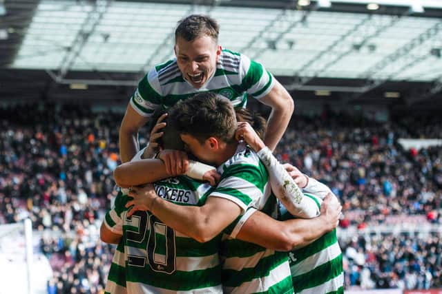 Celtic's Alistair Johnston jumps on top of his team-mates following Cameron Carter-Vickers' goal in the 3-0 win over Hearts.
